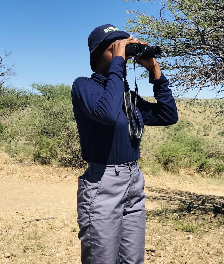A woman looking through binoculars.