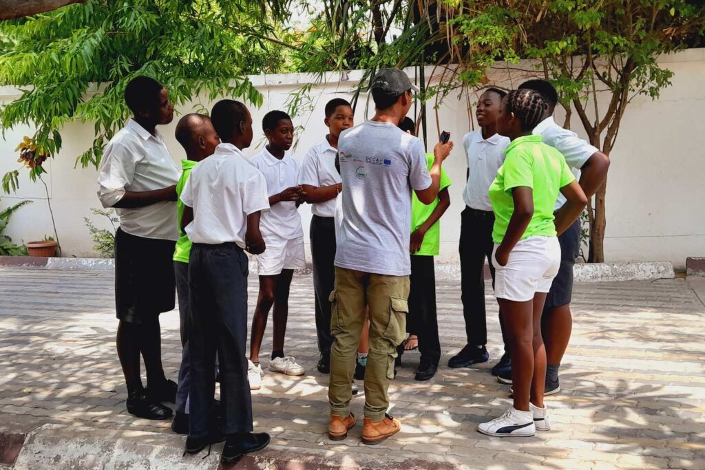 A group of children listening in a circle.