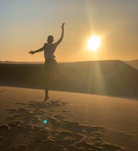 Woman jumping in the desert.