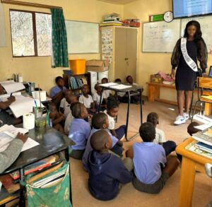 Miss World Namibia addressing young schoolchildren.