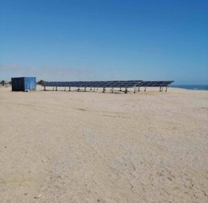 Solar panels next to the ocean.