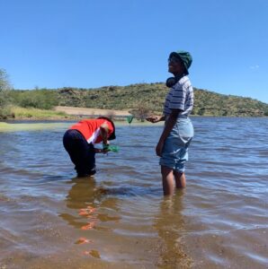 Knee deep collecting samples.