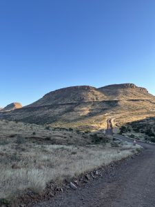 A winding road next to a mountain